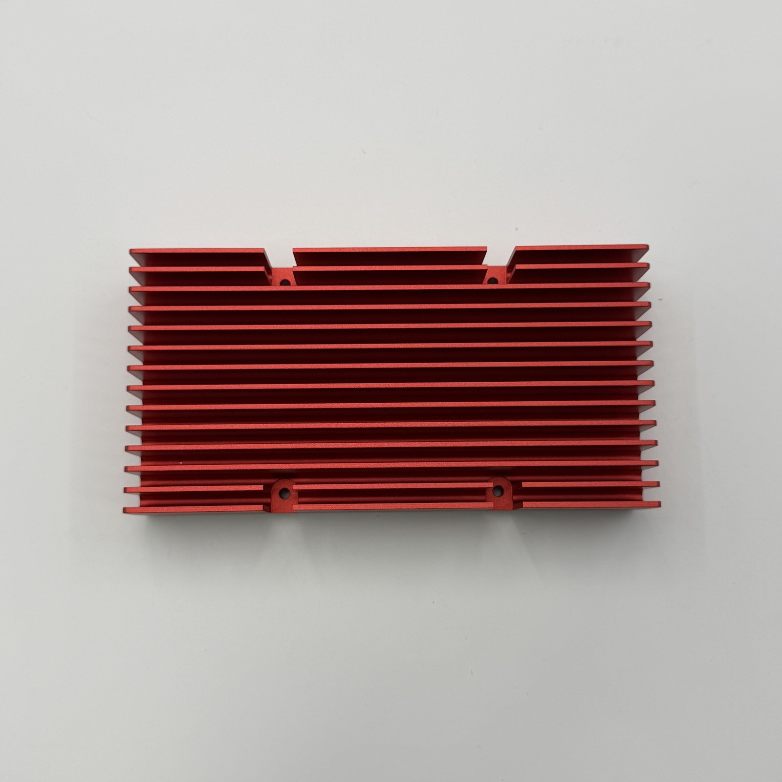 JADE-CNC sample-library photo of a CNC machined heat sink with red surface finish