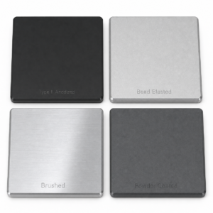 Four 6061-T6 aluminum sample plates showing Type II anodized, bead blasted, brushed, and powder coated surface finishes